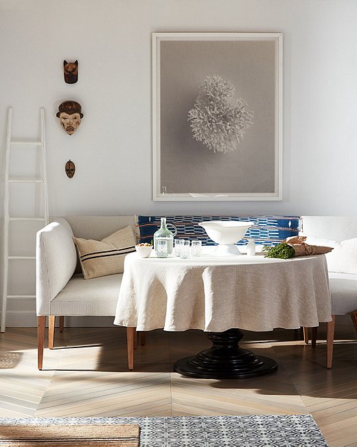 Whites, creams, dashes of blue: a perfect Mediterranean palette. The photo in the room above is White Coral by Dawn Wolfe.
